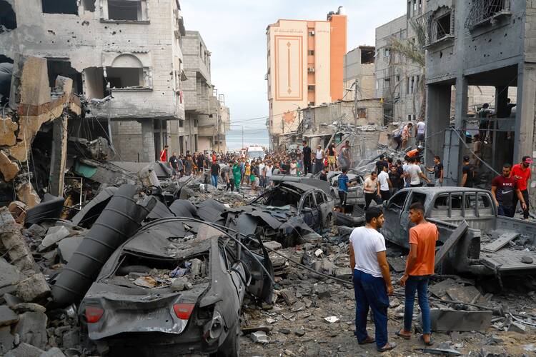 Palestinians inspect damages in the aftermath of Israeli strikes, following a Hamas surprise attack at Beach refugee camp, in Gaza City, Oct. 9, 2023. The Hamas-Israel war has entered a new phase, with more than 1,100 dead. (OSV News photo/Mohammed Salem, Reuters)