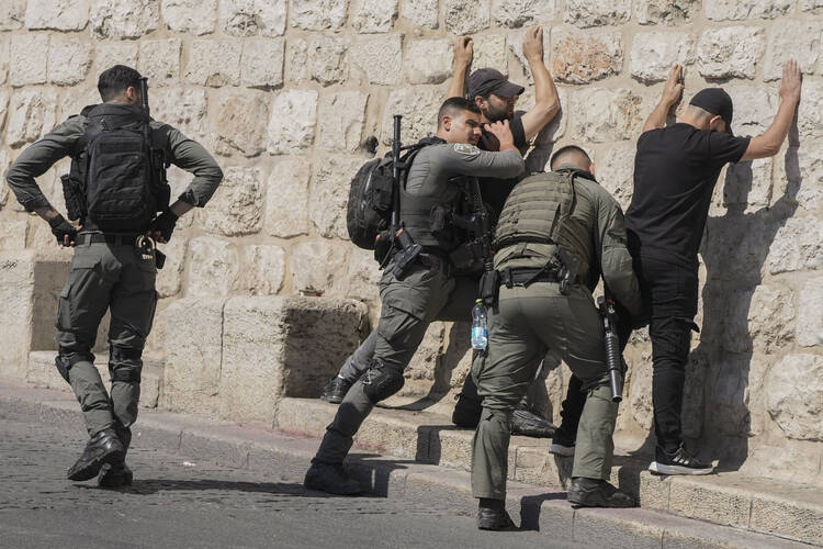 Israeli forces conduct a security check on Palestinians outside Jerusalem's Old City, on Oct. 13, 2023. (AP Photo/Mahmoud Illean)