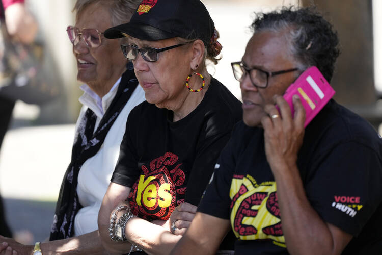 Indigenous women sit on a bench at a polling place in Sydney as Australians cast votes on Oct. 14, 2023, in a referendum that sought to enshrine an advocacy committee for Indigenous peoples in that nation’s Constitution. (AP Photo/Rick Rycroft)