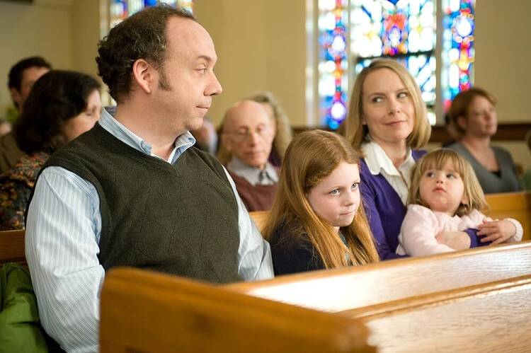 Paul Giamatti, Amy Ryan, Clare Foley and Sophie Kindred in a scene from “Win Win” (IMDB)