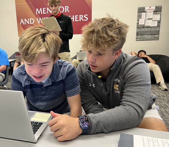 Special needs student Peter Marvin, a freshman, completes an assignment with the assistance of Landon Lewis, a senior and one of his peer mentors, at DeSmet Jesuit High School in St. Louis on Sept. 6, 2023 