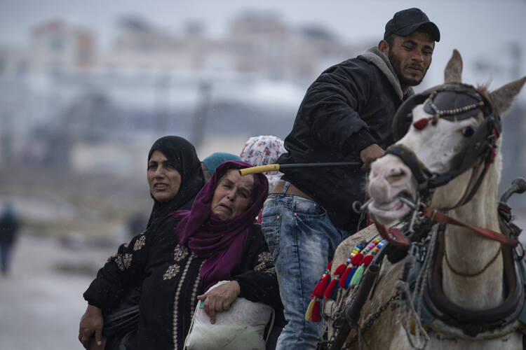 Palestinians arrive in the southern Gaza town of Rafah after fleeing an Israeli ground and air offensive in the nearby city of Khan Younis on Jan. 29, 2024. (AP Photo/Fatima Shbair)