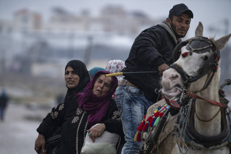 Palestinians arrive in the southern Gaza town of Rafah after fleeing an Israeli ground and air offensive in the nearby city of Khan Younis on Jan. 29, 2024. (AP Photo/Fatima Shbair)