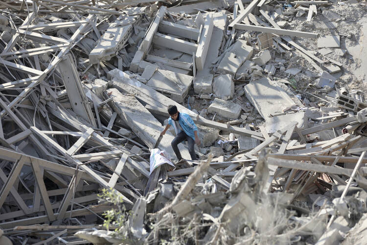 Palestinians walk through the destruction left by the Israeli air and ground offensive on the Gaza Strip in Gaza City on Feb. 10, 2024. (AP Photo/Mohammed Hajjar)