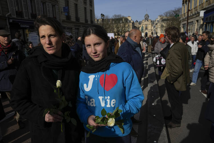 A pro-life activist wears a shirt that reads 'I love life' near the Palace of Versailles during the Congress session of both Houses of Parliament in Versailles, on March 4. (AP Photo/Michel Euler)
