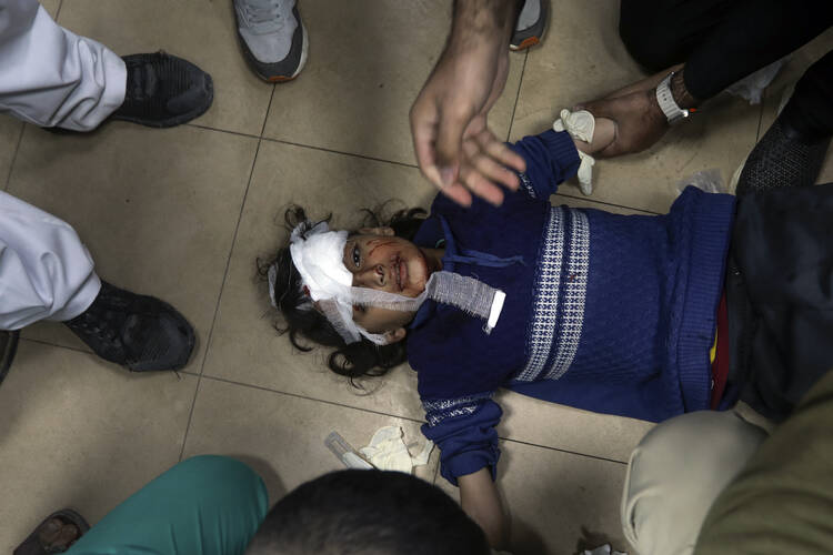 A child wounded in an I.D.F. bombardment is brought to Al Aqsa hospital in Deir al Balah, Gaza Strip, on March 25. (AP Photo/Ismael abu dayyah)