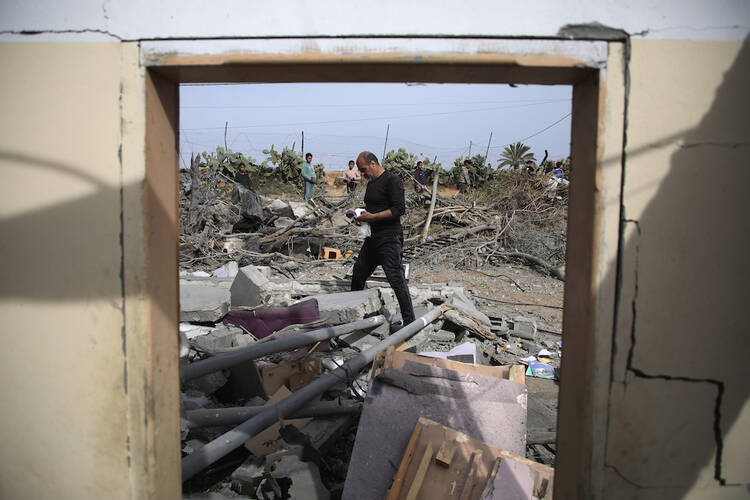 Palestinians inspect the ruins of a residential building for the Abu Muammar family after an Israeli airstrike in Rafah, southern Gaza Strip, Friday, March 29, 2024. (AP Photo/Hatem Ali)