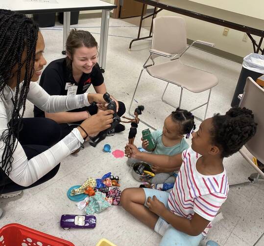 Volunteers and residents at play at Room at the Inn