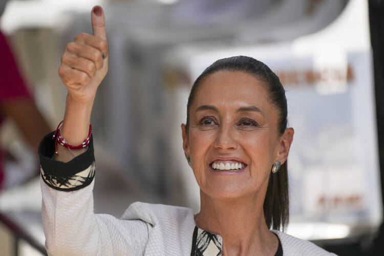 Ruling party presidential candidate Claudia Sheinbaum shows her ink-stained thumb after voting during general elections in Mexico City, Sunday, June 2, 2024. (AP Photo/Marco Ugarte)
