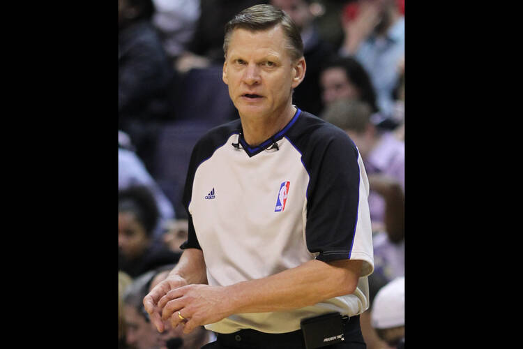Steve Javie, a former NBA referee, wearing his referee uniform during a basketball game.