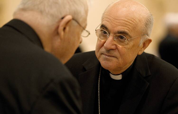 Archbishop Carlo Maria Vigano, apostolic nuncio to the United States, talks with a U.S. bishop during the bishops' meeting in Baltimore in this Nov. 13, 2012, file photo (CNS photo/Nancy Phelan Wiechec).