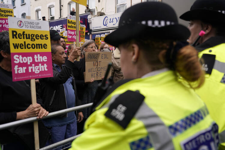 Police halt a counterprotest organized against a planned far-right anti-immigration protest in Walthamstow, London, on Aug. 7. (AP Photo/Alberto Pezzali)(AP Photo/Alberto Pezzali)
