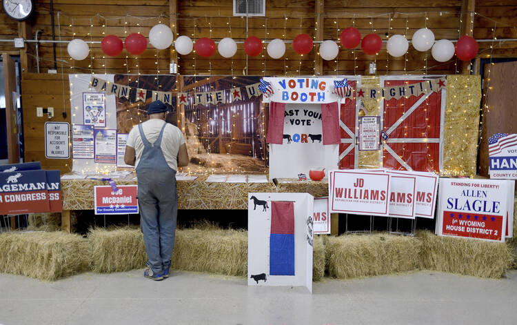 A get-out-the-vote display, with candidate signs among bales of hay, at the Niobrara County Fair in Lusk, Wyo., on July 31, 2024. (AP Photo/Thomas Peipert)