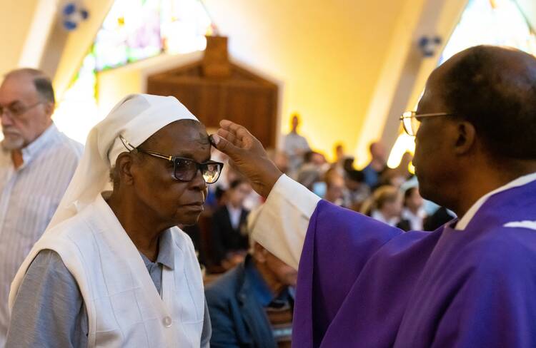 Father Emmanuel Mosoew, an Oblate of Mary Immaculate, distributes ashes to a religious sister at St. Charles Borromeo Church in Johannesburg during Mass on Ash Wednesday, Feb. 22, 2023. Father Mosoew is a theology professor at St. Augustine University in Johannesburg. (OSV News photo/Sam Lucero)
