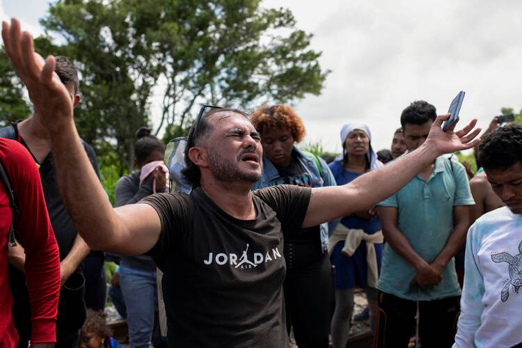 Migrants in Sayula de Aleman, Mexico, Aug. 22, 2024, pause for prayer on their journey toward the U.S. border. (OSV News photo/Angel Hernandez, Reuters)