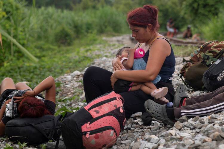 A migrant feeds her child during a pause along a railroad track in Sayula de Aleman, Mexico, Aug. 22, 2024, during their journey toward the U.S. border. (OSV News photo/Angel Hernandez, Reuters)