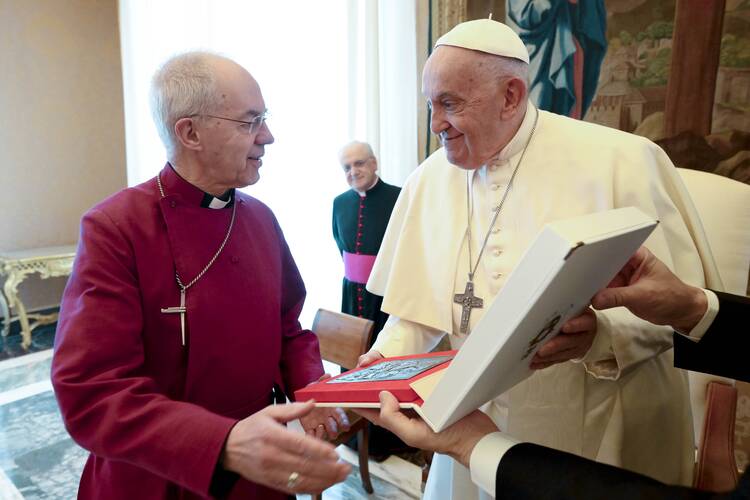 Pope Francis presents a gift to Justin Welby, then the archbishop of Canterbury, during a meeting with Anglican primates in the Apostolic Palace at the Vatican on May 2, 2024. (CNS photo/Vatican Media)