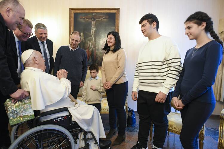 Pope Francis greets a Christian family from Syria at the nunciature in Brussels Sept. 28, 2024. As refugees, they had reached Belgium thanks to the help of the Rome-based Community of Sant'Egidio and its "humanitarian corridors." (CNS photo/Vatican Media)