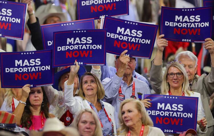 Delegates hold "Mass deportation now!" signs on Day 3 of the Republican National Convention at the Fiserv Forum in Milwaukee July 17, 2024. (OSV News photo/Brian Snyder, Reuters)