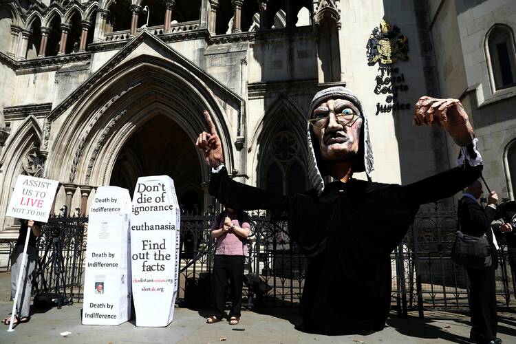 Anti-euthanasia protesters demonstrate outside the Royal Courts of Justice in London in July 2017.  (CNS photo/Neil Hall, Reuters)