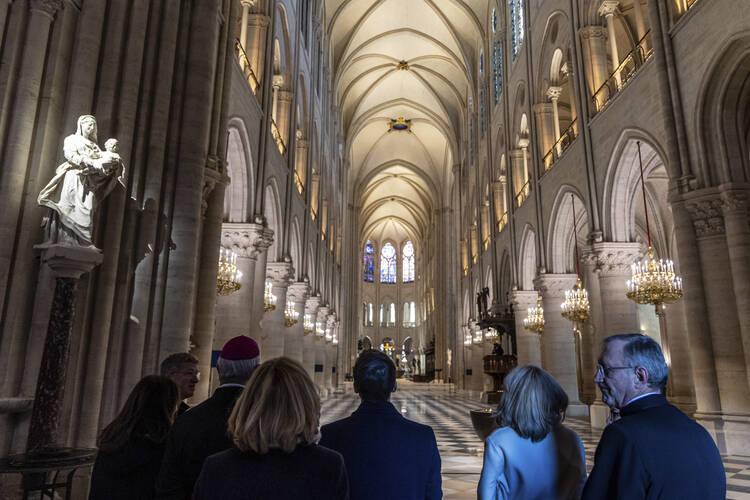 French President Emmanuel Macron, center, and his wife Brigitte Macron, second right, visit the restored interiors of the Notre-Dame de Paris cathedral on Nov. 29, 2024, in Paris. (Christophe Petit Tesson/Pool via AP)