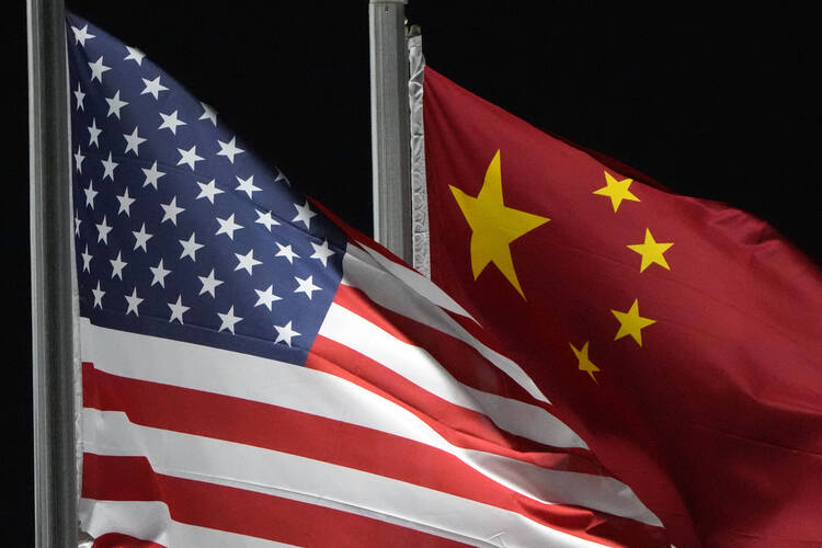The American and Chinese flags at the 2022 Winter Olympics, in Zhangjiakou, China, on Feb. 2, 2022. (AP Photo/Kiichiro Sato, File)