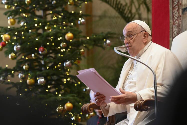 Pope Francis reads his speech to officials of the Roman Curia and the College of Cardinals during his annual pre-Christmas meeting with them in the Hall of Blessing above the atrium of St. Peter's Basilica at the Vatican on Dec. 21, 2024. (CNS photo/Vatican Media)