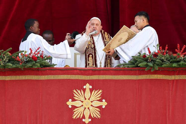 Pope Francis gives his Christmas blessing "urbi et orbi" (to the city and the world) from the central balcony of St. Peter's Basilica at the Vatican Dec. 25, 2024. (CNS photo/Lola Gomez)