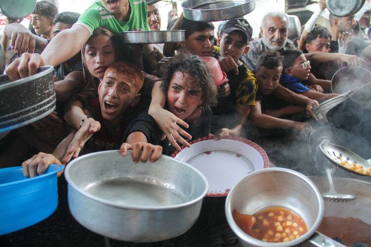 Young Palestinians gather to receive food cooked by a charity kitchen, amid the Israel-Hamas conflict, in the northern Gaza Strip Sept. 11, 2024. (OSV News photo/Mahmoud Issa, Reuters)