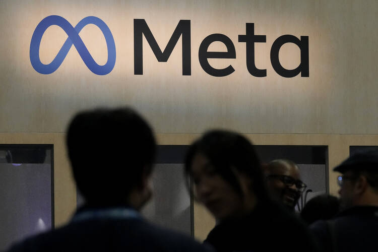 Attendees visit the Meta booth at the Game Developers Conference in San Francisco on March 22, 2023. (AP Photo/Jeff Chiu, File)
