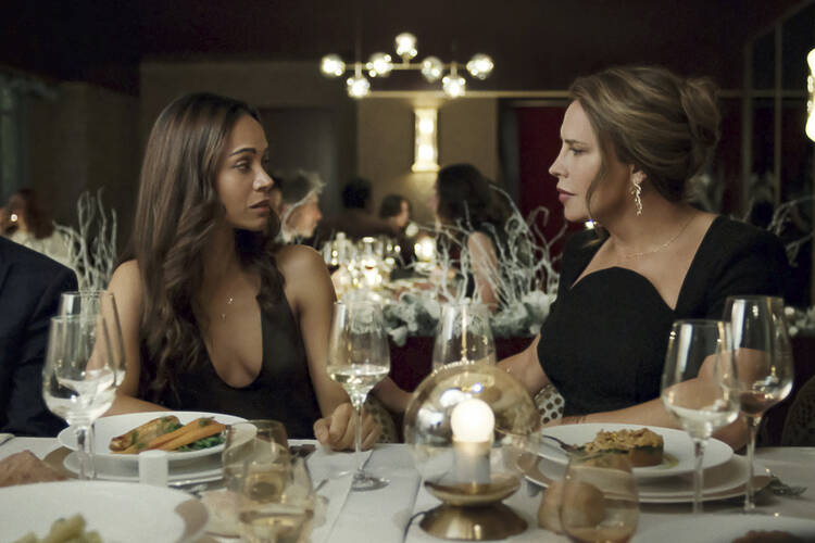 Karla Sofía Gascón, right, and Zoe Saldaña in a scene from "Emilia Pérez" (Shanna Besson/Netflix via AP).