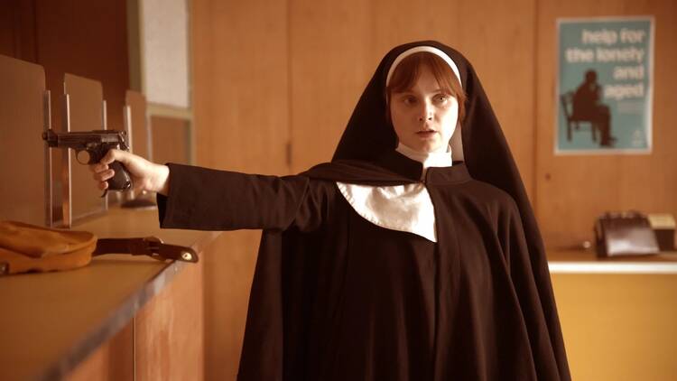 The actress Lola Petticrew dresses as a nun robbing a bank in ‘Say Nothing’