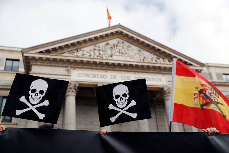 People protest against a law to legalize euthanasia as the Spanish Parliament prepares to vote on it in Madrid in this Dec. 17, 2020, file photo. On March 18, 2021, Spain's parliament legalized physician-assisted suicide. (CNS photo/Susana Vera, Reuters)