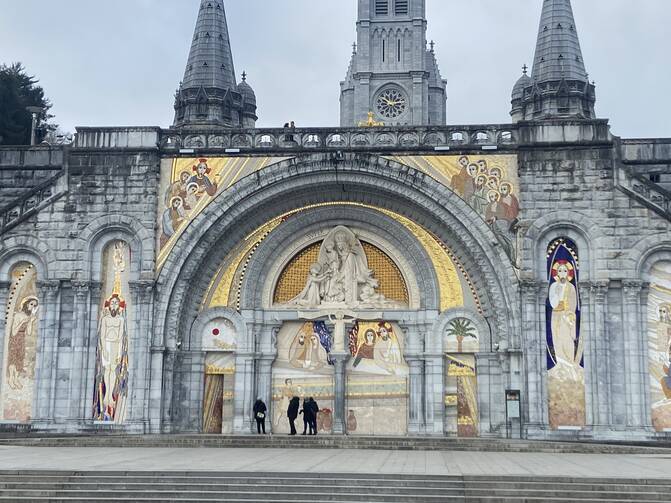 The facade of the Basilica of Our Lady of the Rosary at Lourdes in April 2023, when the artwork of Marko Rupnik, a priest and former Jesuit now under investigation for sexual abuse, was still on view. Lourdes officials announced on March 31 that the sanctuary will cover the mosaics on the door of the basilica. (OSV News photo/courtesy Greg Erlandson)
