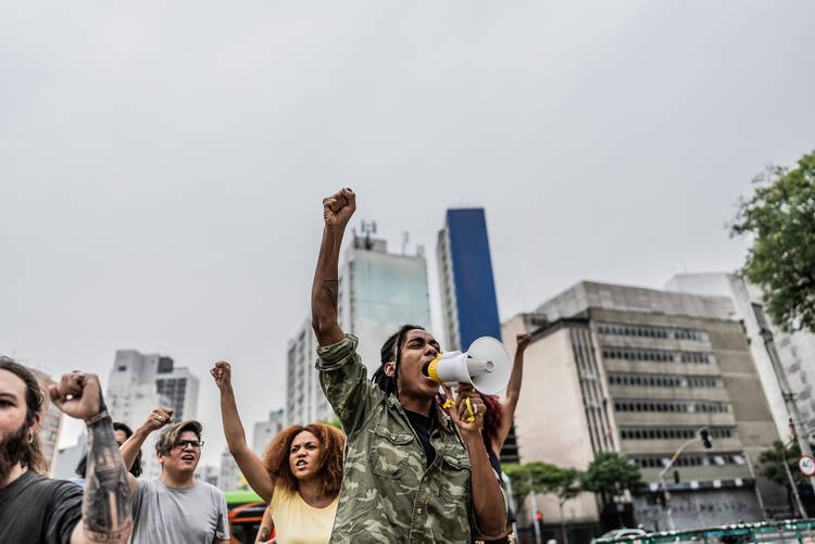 A photo of people outside in a city protesting