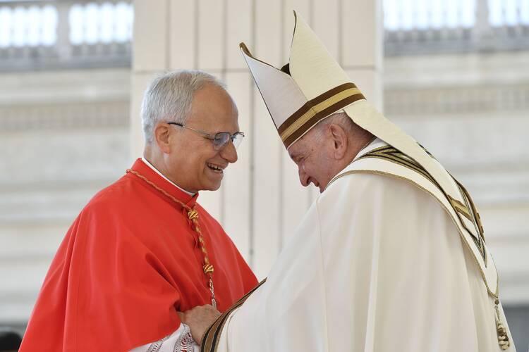 Pope Francis greets then-Cardinal Robert F. Prevost during a consistory in St. Peter's Square at the Vatican on Sept. 30, 2023. (CNS photo/Vatican Media)
