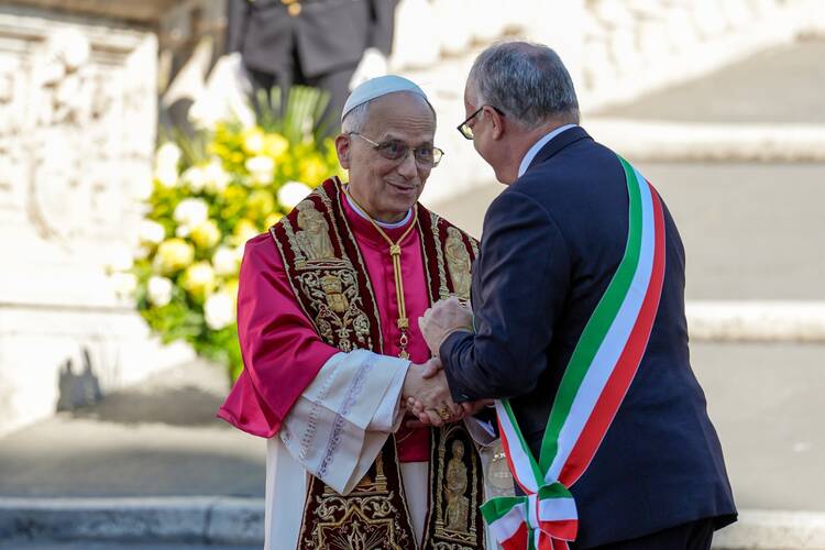 Pope Leo XIV and Rome Mayor Roberto Gualtieri shake hands after exchanging remarks in Aracoeli Square in Rome May 25, 2025. (CNS photo/Lola Gomez)