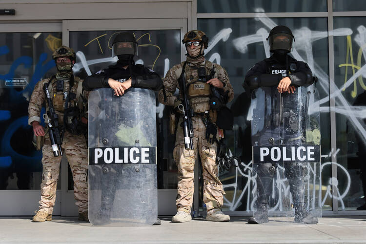 U.S. Customs and Border Protection officers guard an entrance of the Federal Building in Los Angeles on June 10, during a protest demonstration against Immigration and Customs Enforcement (ICE) raids. (Gabrielle Lurie/San Francisco Chronicle via AP)