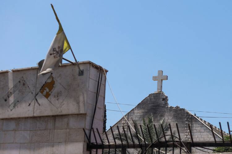 The Vatican City flag flies July 18, 2025, at Holy Family Church in Gaza City which was hit in an Israeli strike July 17. (OSV News photo/Khamis Al-Rifi, Reuters)