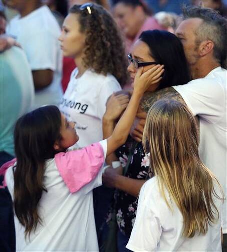 Friends and family grieve during a vigil to honor Pulse night club victim Corey Connell at Publix in College Park, Fla. (Stephen M. Dowell(/Orlando Sentinel via AP)