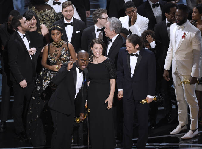 Barry Jenkins, foreground left, and the cast accept the award for best picture for "Moonlight" at the Oscars on Sunday, Feb. 26, 2017, at the Dolby Theatre in Los Angeles. (Photo by Chris Pizzello/Invision/AP)