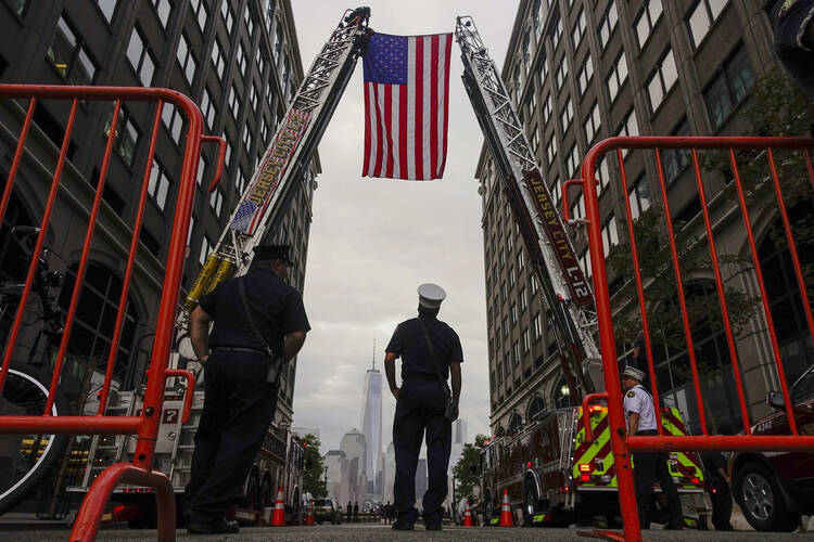 Firefighters attend a Sept. 11 ceremony in Exchange Place, N.J., marking the 13th anniversary of the 9/11 terrorist attacks on the World Trade Center (CNS photo/Eduardo Munoz, Reuters).