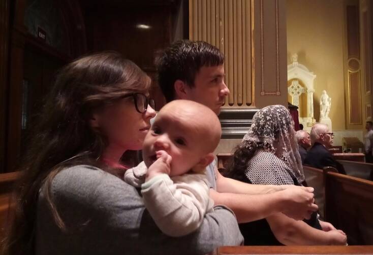 Kevin and Sarah Leopold attend a Sept. 14 prayer vigil with their son Ambrose at the Cathedral Basilica of SS. Peter and Paul in Philadelphia. The vigil was in response to recent clerical sexual abuse scandals. (CNS photo/Gina Christian, catholicphilly.com)