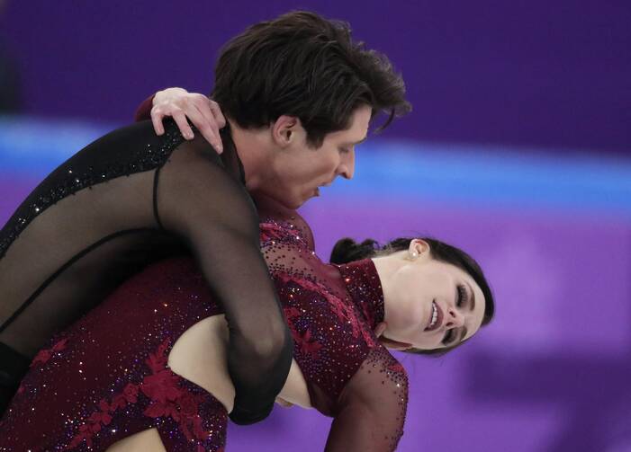 Scott Moir and Tessa Virtue of Canada perform in the ice dance free dance figure skating team event at the 2018 Winter Olympics in Gangneung, South Korea, Monday, Feb. 12 (AP Photo/Julie Jacobson).