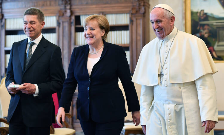 Pope Francis smiles with German Chancellor Angela Merkel and her husband Joachim Sauer, left, on the occasion of their private audience, at the Vatican, Saturday, June 17, 2017. (Ettore Ferrari/Pool Photo via AP)