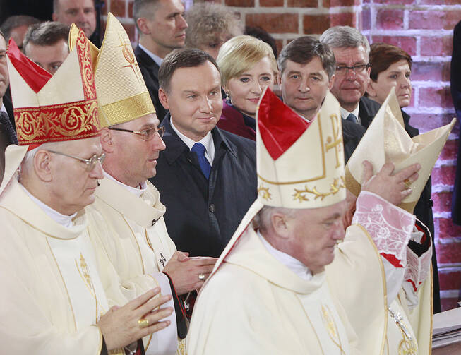 In this file photo taken on April 14, 2017, Polish bishops walk by President Andrzej Duda, First Lady Agata Kornhauser-Duda, parliament speakers and Prime Minister Beata Szydlo as they arrive to celebrate a special Mass during ceremonies marking 1,050 years of the nation's Catholicism at the 10th-century cathedral in Gniezno,Poland considered to be the cradle of Poland's Catholic faith. (AP Photo/Czarek Sokolowski)