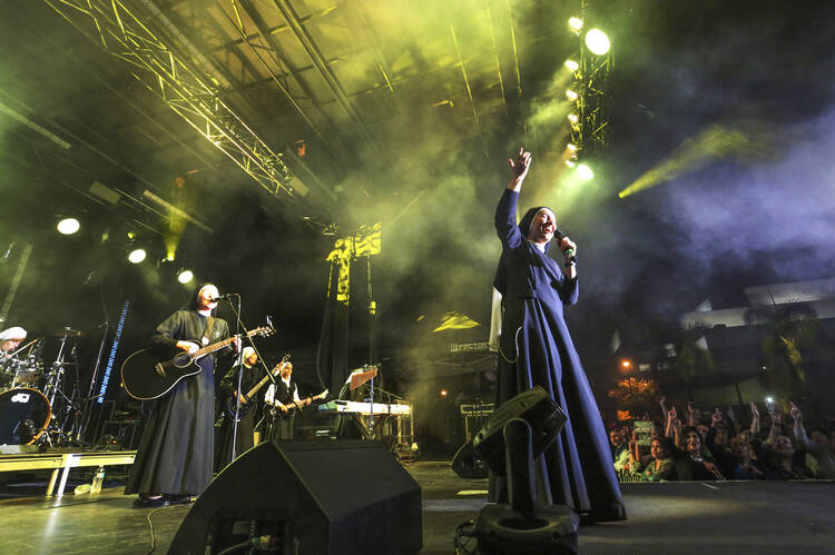 In this Friday, Sept. 8, 2017, photo provided by Diocese of Orange, "Siervas," a nun rock band performs live at the Festival de Cristo at Christ Cathedral in Garden Grove, Calif. The band known as Siervas was born in a Peruvian convent three years ago and since has gained an international following drawn by their smiling faces and soaring songs. (Challenge Roddie/Diocese of Orange via AP)