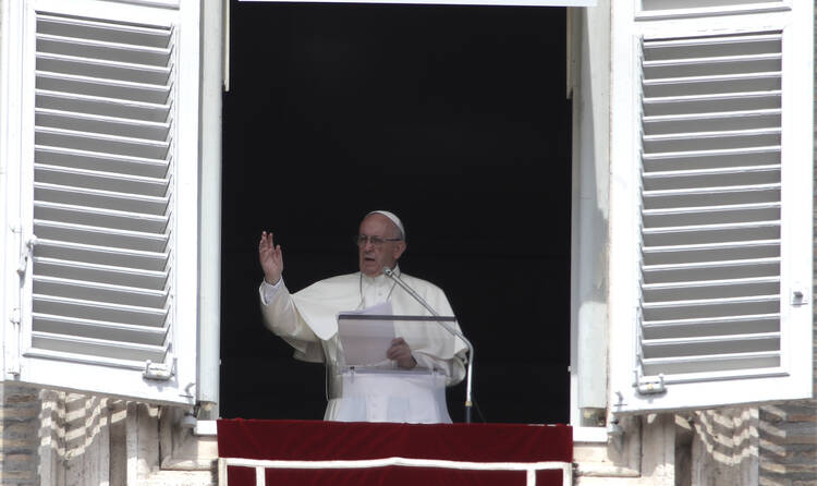 Pope Francis delivers his blessing during the Angelus noon prayer from the window of his studio overlooking St. Peter's Square, at the Vatican, on Sunday, Sept. 24, 2017. (AP Photo/Alessandra Tarantino)