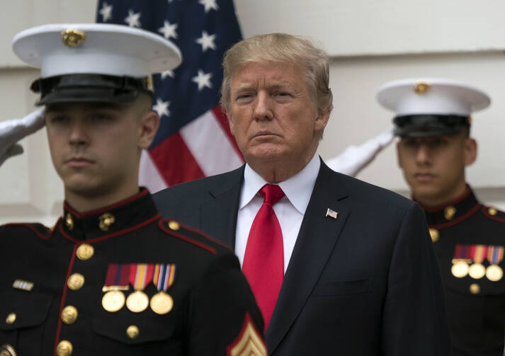 President Donald Trump stands behind and in front of members of a Marine honor guard as he greets Canadian Prime Minister Justin Trudeau and Sophie Gregoire Trudeau as they arrive at the White House on Oct. 11. (AP Photo/Carolyn Kaster)