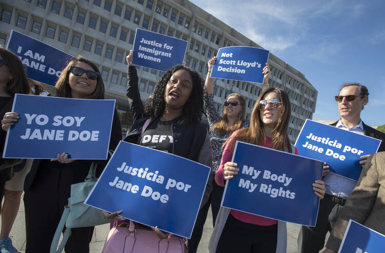 Activists with Planned Parenthood demonstrate in support of a pregnant 17-year-old being held in a Texas facility for unaccompanied immigrant children to obtain an abortion, outside of the Department of Health and Human Services in Washington, Friday, Oct. 20, 2017. 
